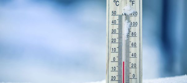 Thermometer on snow shows low temperatures – zero. Low temperatu
